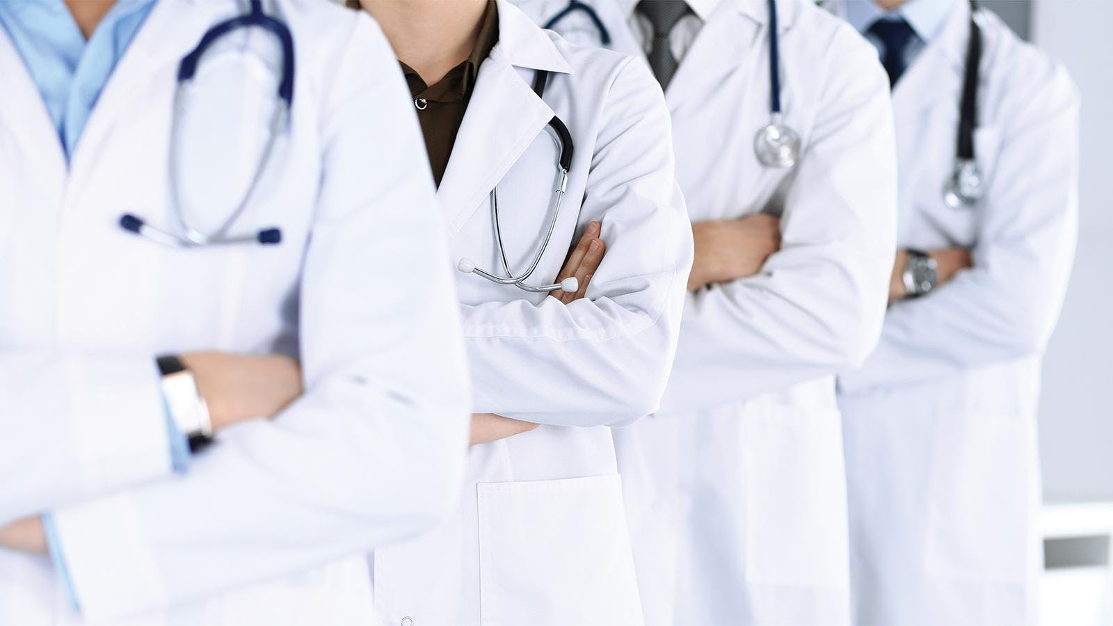 Group of doctors standing together and crossing their arms