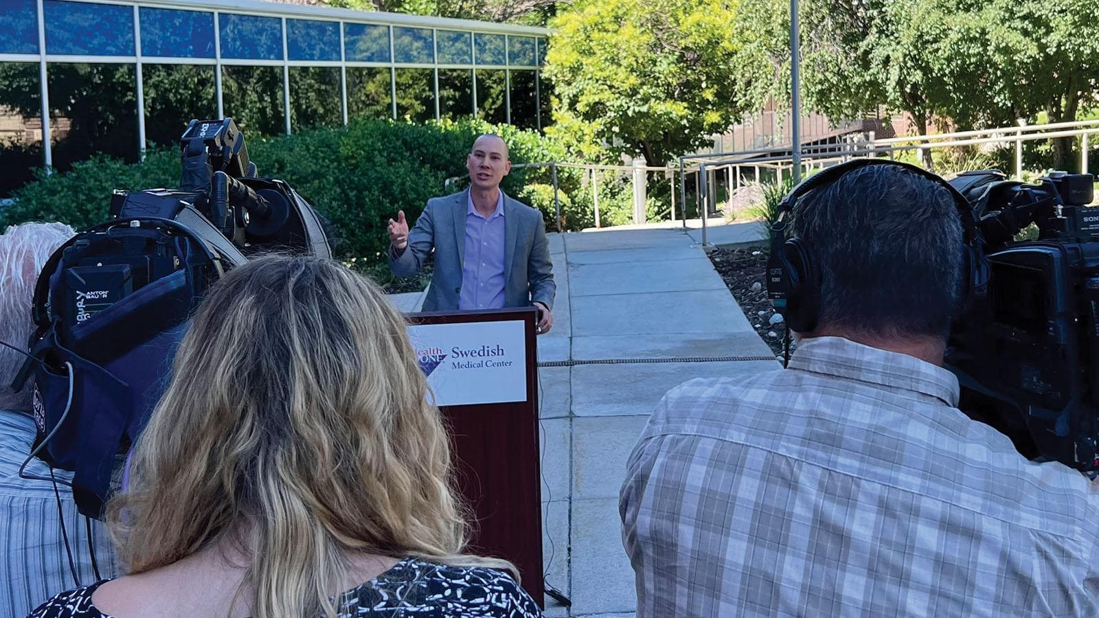 CarePoint Health doctor Don Stader standing behind a podium at a press conference