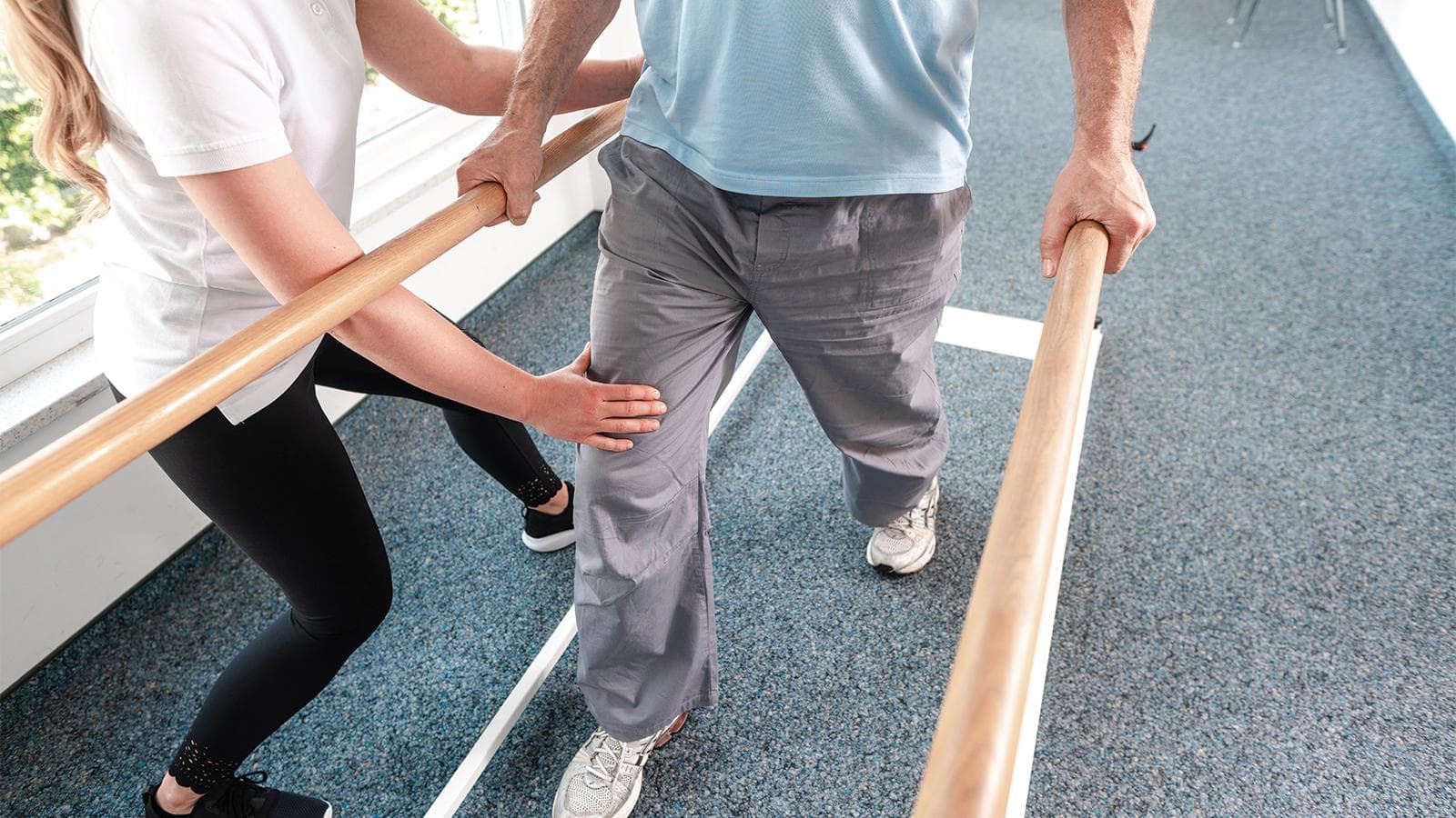 A doctor helping a patient walk